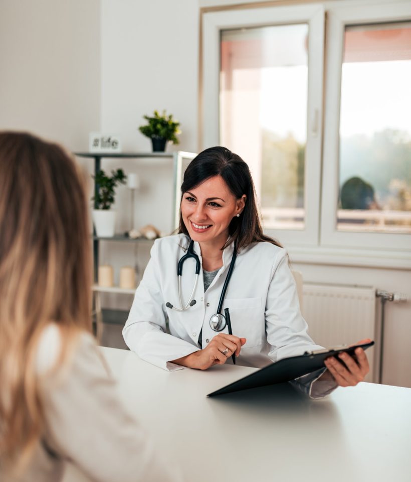 Female doctor and female patient talking about test results.